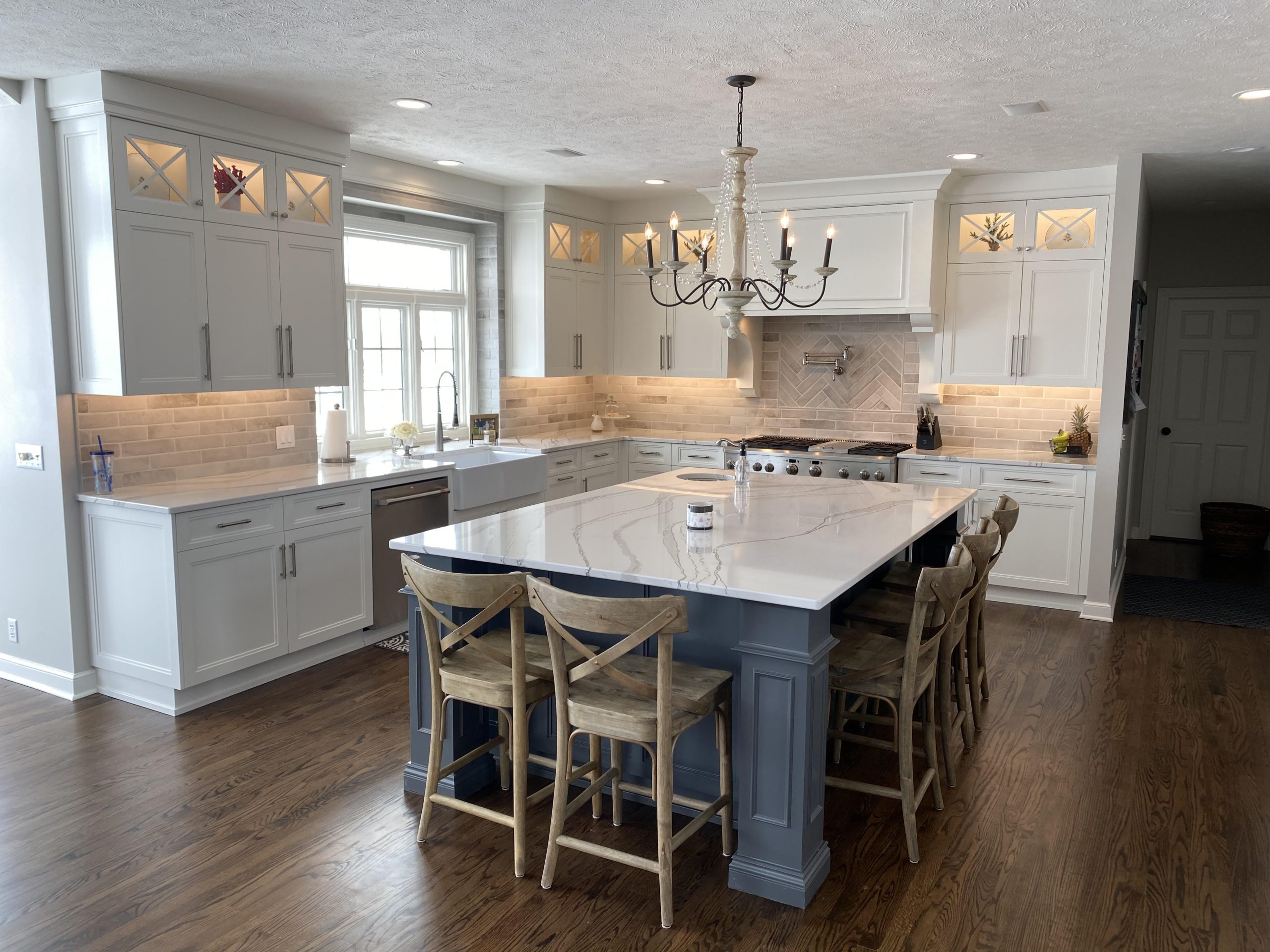 white kitchen with blue island